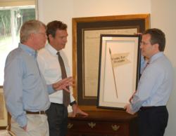 Stephen Desloge (left), John Reznikoff and Seth Kaller (right) discuss placement of various items in the Rockwell Art and Framing Gallery.